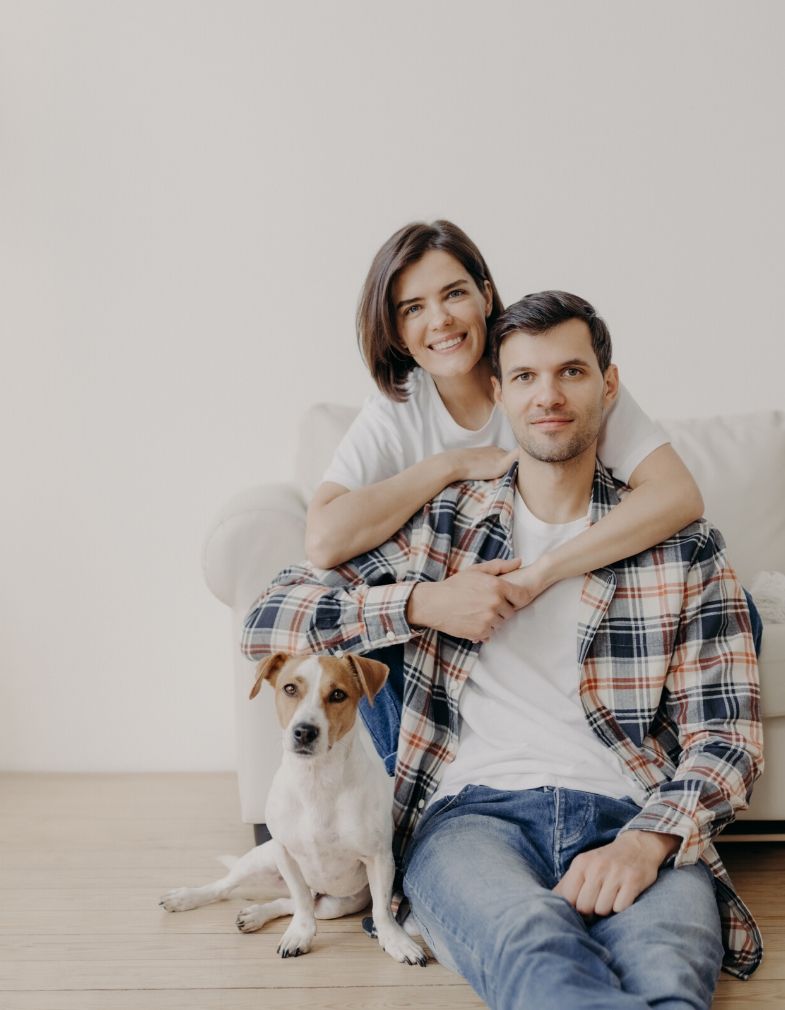 Couple sitting with their dog happy to get their relationship working