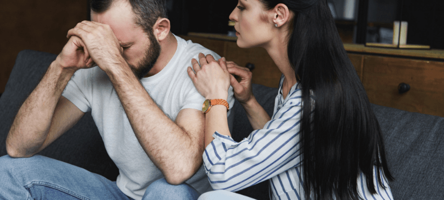 A woman rests her hands on her conflicted partner's shoulder as they bow their head. This could symbolize the conflicting emotions when recovering from an affair. Idit Sharoni is an affair recovery expert that offers counseling for recovering from infidelity in Florida. Contact her today for affair recovery support in Florida and worldwide. 