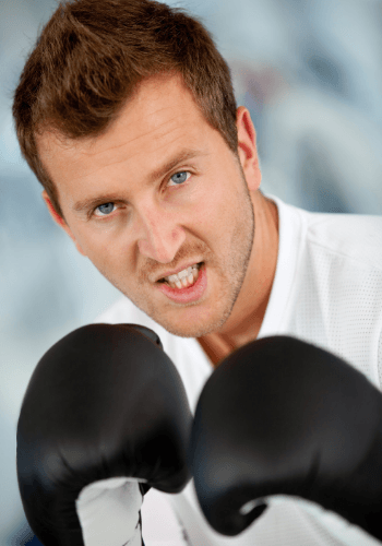 Photo of a man in a defensive position with boxing gloves representing how it's common to feel defensive during arguments in a relationship. We offer an affair recovery program available everywhere from London to Illinois, New York & Washington. For couples in Florida, we also offer marriage counseling & couples therapy for infidelity & relationship problems.