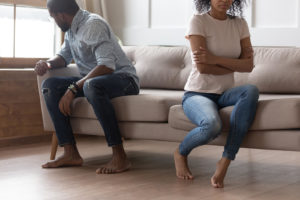 A couple sit facing away from one another on a couch. This could represent the disconnect following an affair. PTSD from cheating can keep many from recovering from infidelity in Florida. But, an affair recovery program with Idit Sharoni can help. Learn more about how to apologize for cheating today! 33311 | 33313 | 33180