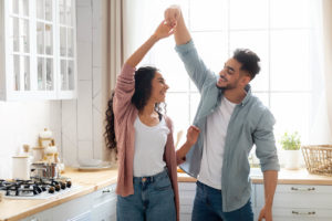 A couple dances with one another in the kitchen for Idit Sharoni. Contact a couples therapist in Florida to learn more about online relationship therapy in Florida. 33179 | 33160 | 33313 