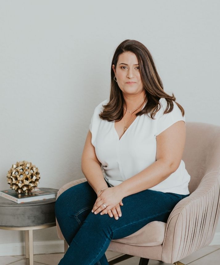 Yael Haklai-Neagu, LMFT sits in a chair for a photo for Idit Sharoni, LMFT. Contact a couples therapist in Miami, FL to learn more about our services. We offer couples therapy in Florida, support recovering from infidelity in Florida, and other services! 33180 | 33908 | 33179