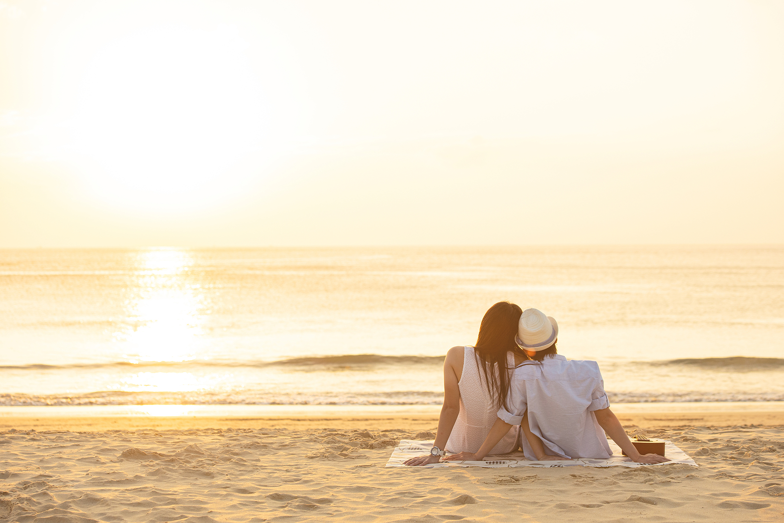 A couple sit on the beach as they watch the waves. A marriage counselor in Florida can provide support for any couple. Contact a couples thearpist in Florida for support with couples therapy in Miami, FL.