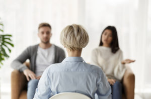 An image of a therapist sitting across from a couple as they listen to their concerns. This could represent a couples therapist in Florida meeting with a couple. Contact an affair recovery expert to learn more about couples therapy in Florida. We offer couples therapy and marriage counseling in FL and other services! 33311 | 33908 | 33180