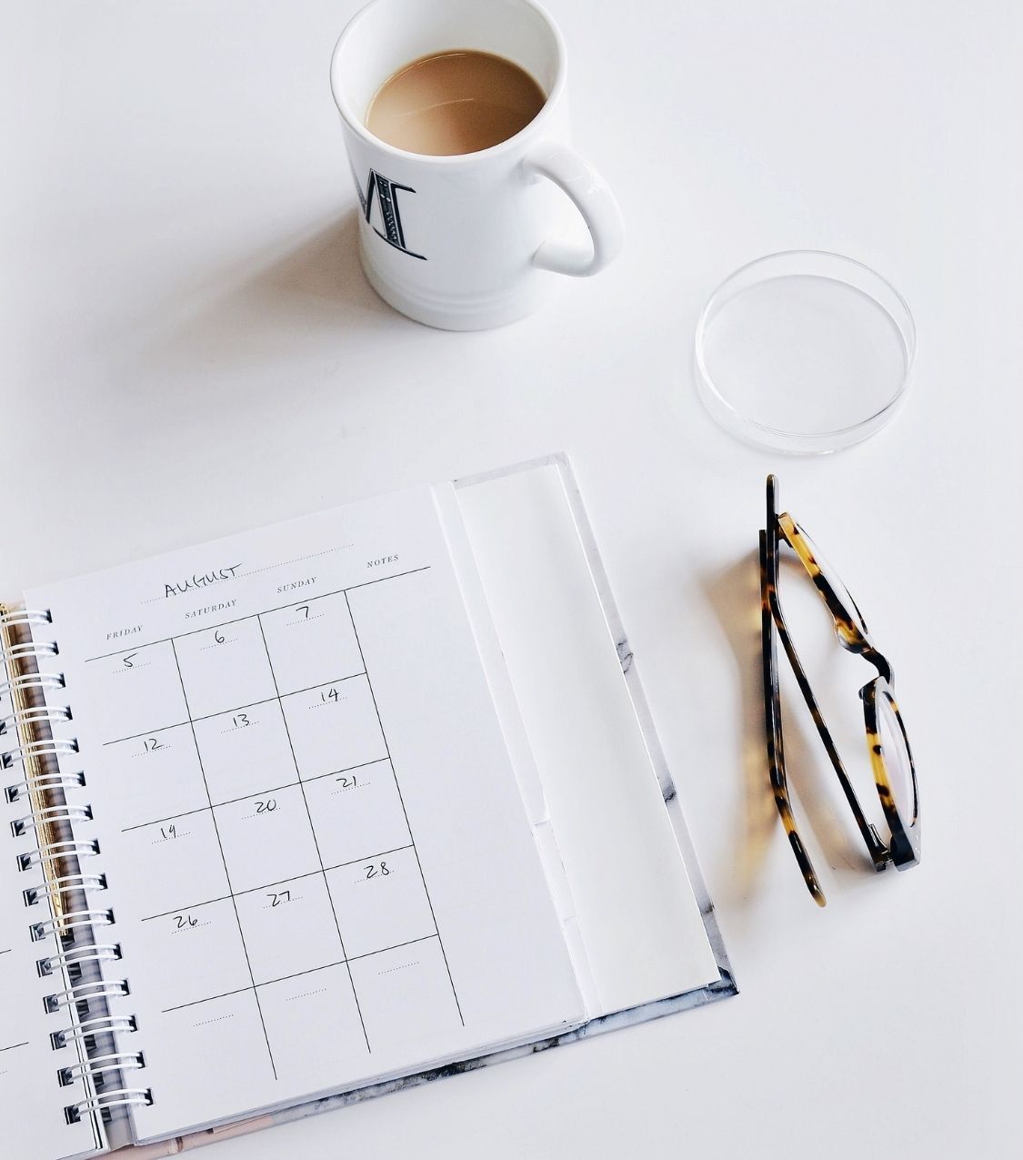 A calendar planner and eyeglasses on desk to determine the length of affair recovery | Affair Recovery Experts | Florida | Chicago | New York | USA