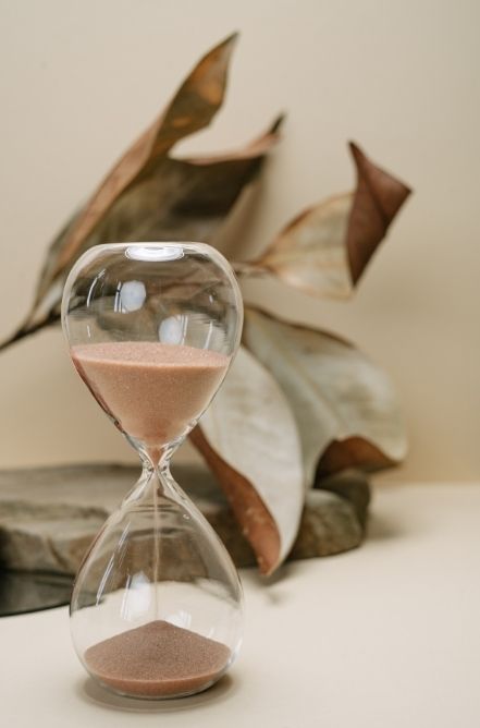 Clear hourglass besides leaves | Affair Recovery Experts | Florida | Chicago | New York | USA