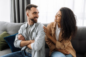 Shows a couple turning towards each other smiling. Represents how a couples therapist in miami, fl will support you on your journey turning toward your partner.