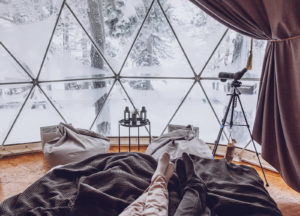 Shows a glass igloo with a couple laying inside. Represents how a couples therapist in Naples, FL will help you and your partner find fun outside of your comfort zone. 