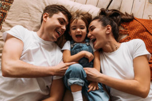 Shows a happy couple with their child. Symbolizes how couples therapy and marriage counseling in fl can help you stop trying to change your partner.