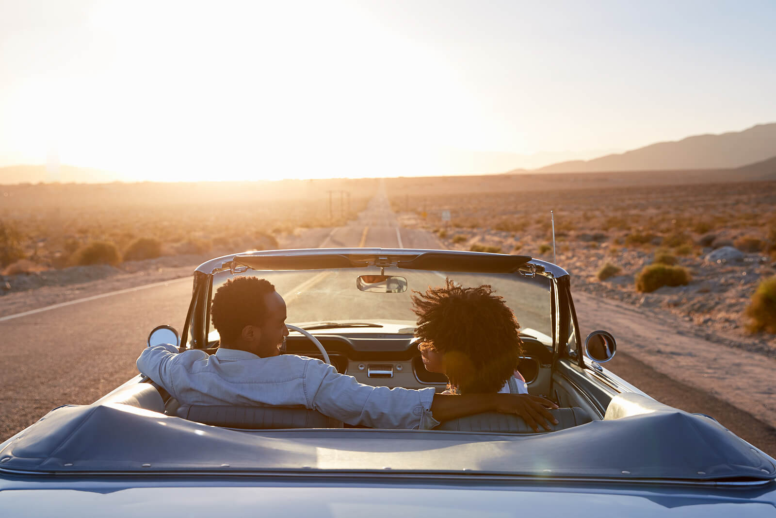 Photo of a couple driving in a car during sunset smiling at each other. Are you and your partner working on your intimacy and connection? With marriage counseling in Miami, FL you can begin to help your relationship by defeating the barriers blocking your communication.