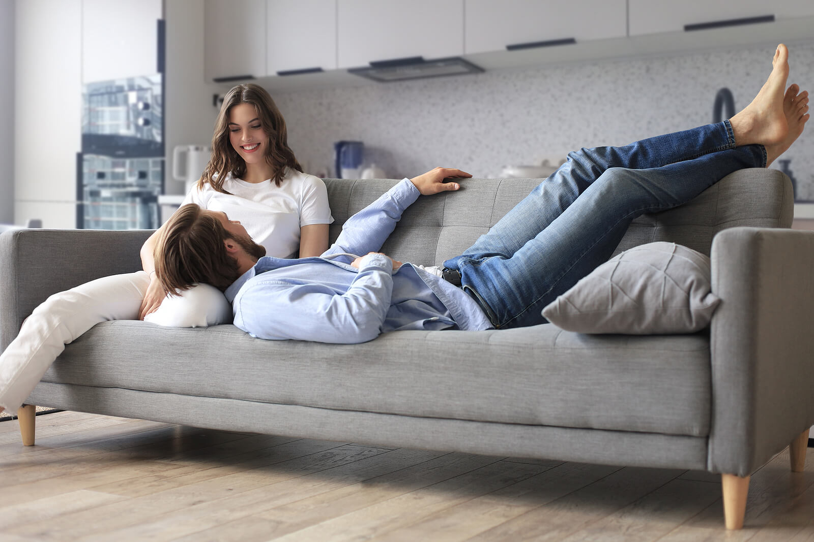 Photo of a woman and man laying on a couch smiling at each other. Communication is important in any relationship. Discover tips from a communication therapist in Florida on learning effective communication.