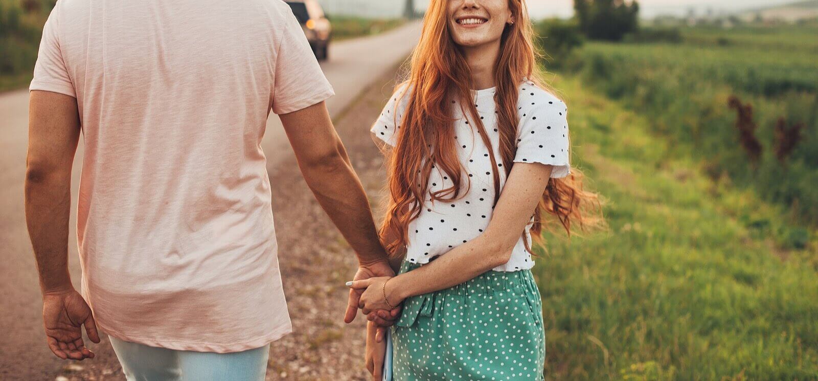 Photo of a happy couple smiling and walking down the side of a road. Looking to reconnect with your partner and repair relationship damage. Discover how a couples therapist in Florida can help you regain trust and communication in your relationship.