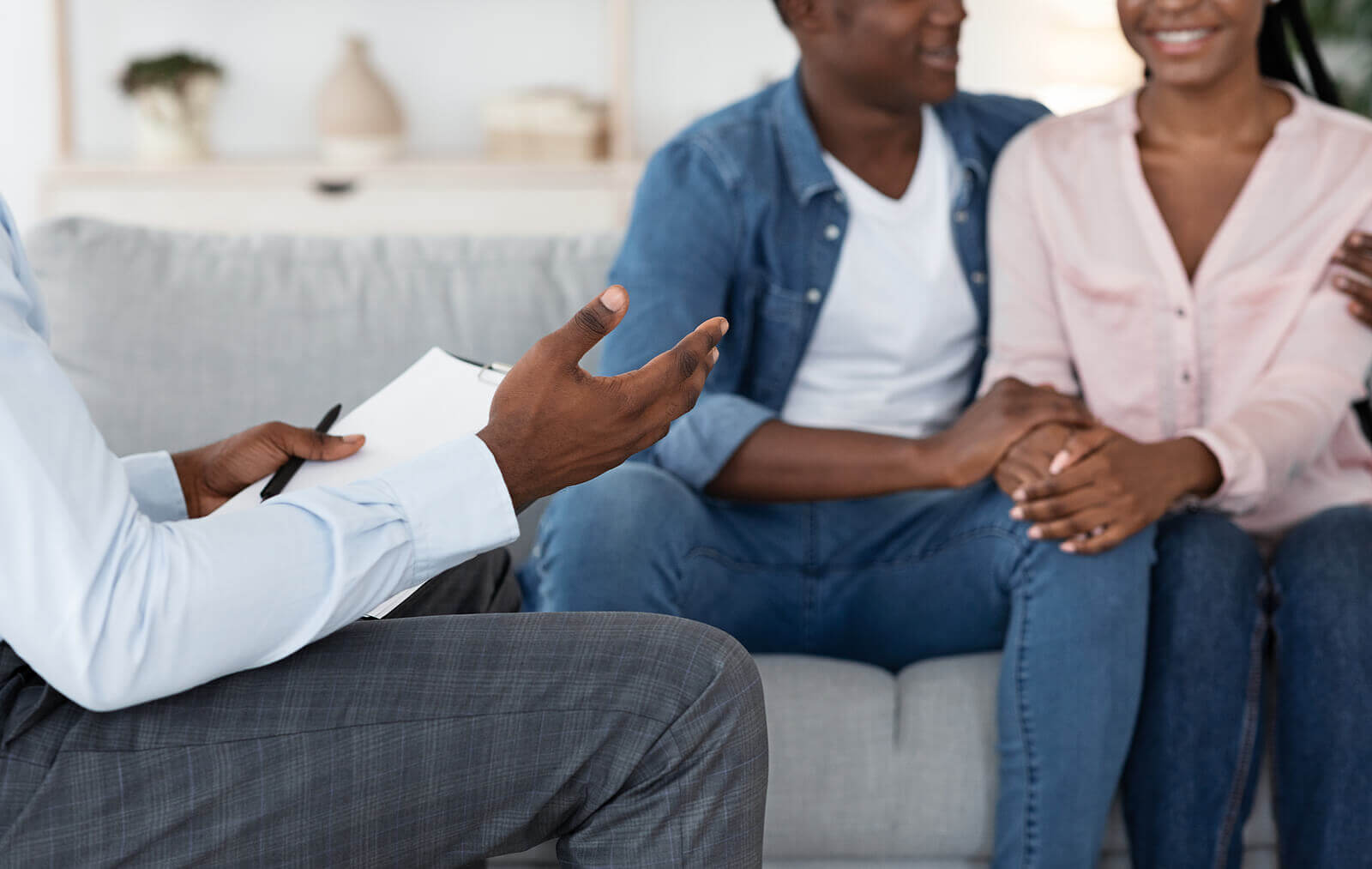 Photo of a couple sitting on a couch happily talking with a couples therapist. Learn how to find the best couples therapist in Florida to help you begin to strengthen your relationship and reconnect with your partner.