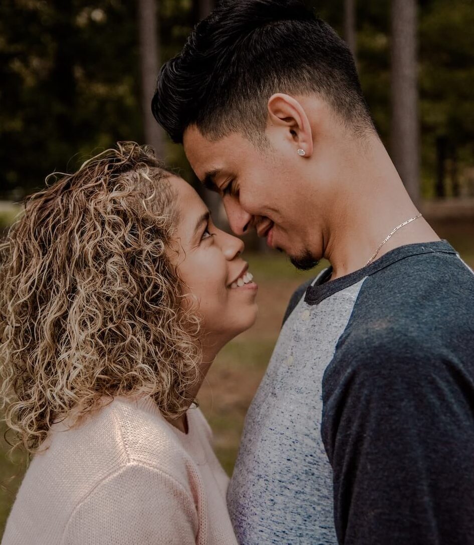 Image of a smiling couple putting their noses together smiling at each other. Discover how you can avoid resentment in your relationship with healthy communication and marriage counseling in Miami, FL.