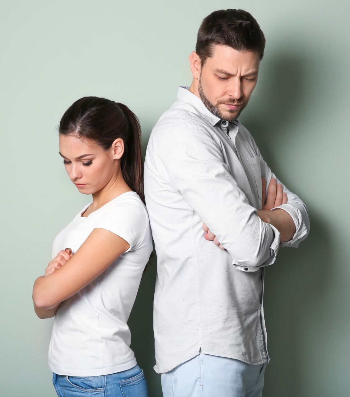Image of an upset couple with their arms crossed and backs together. Discover how affair recovery in Orlando, FL can help you and your partner overcome the infidelity that haunts your relationship.