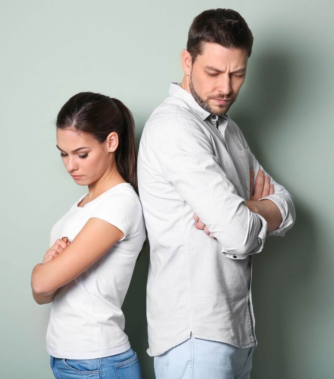 Image of an upset couple with their backs to each other and arms crossed. With the help of couples therapy in Miami, FL you and your partner can work on the conflict affecting your intimacy.