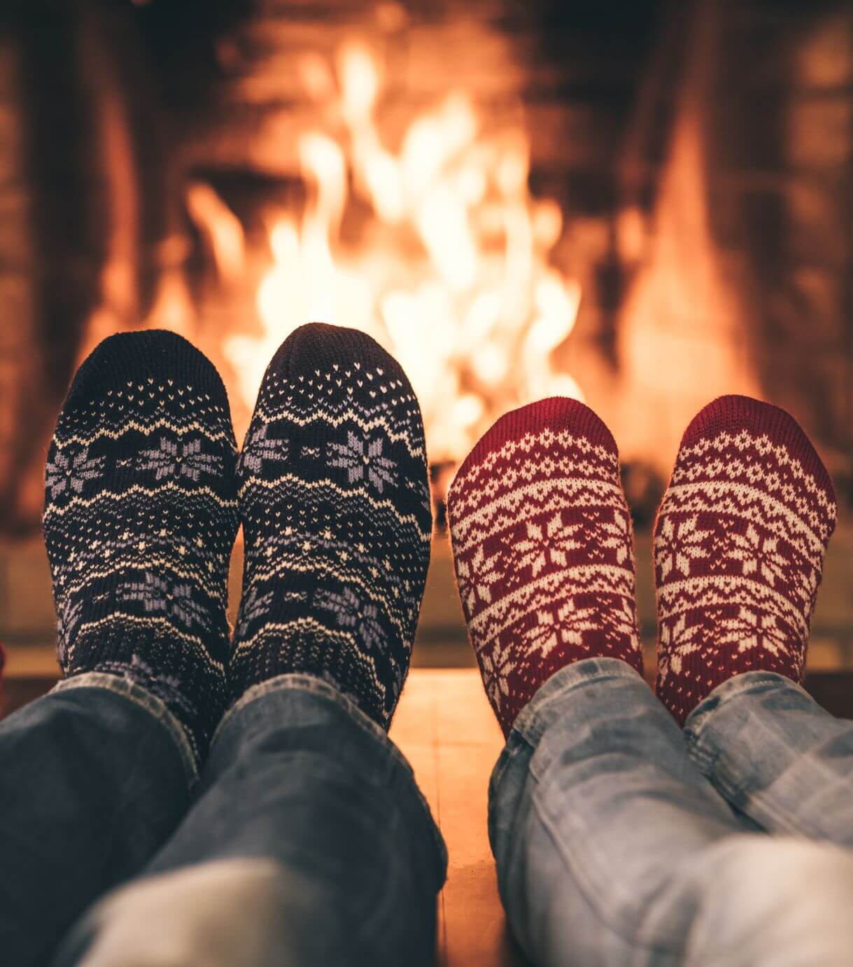 Image of a couples feet in front of a fireplace. Begin rekindling your romance during the holiday season with the support of couples therapy in Miami, FL.