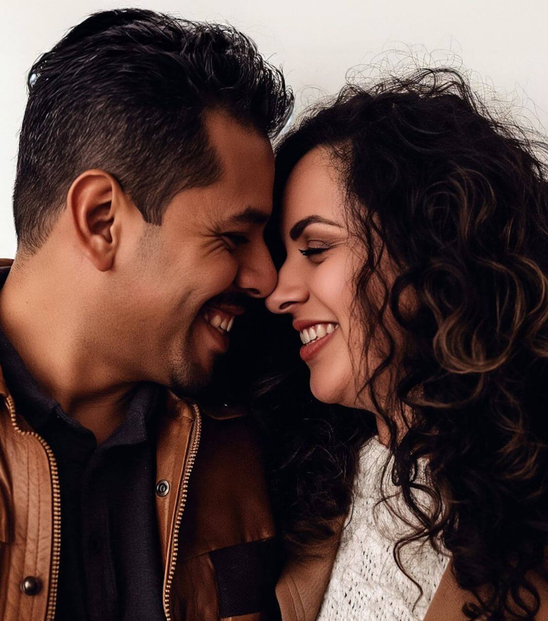 Smiling couple closing their eyes and placing their faces close together. Not sure if couples therapy is right for you? With the support of a compassionate couples therapist in Miami, FL you and your partner can rebuild your connection in positive ways!
