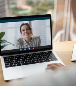Laptop screen showing a therapist smiling during a video call, illustrating how counseling sessions over Zoom and virtual couples therapy help ease camera discomfort for couples in Florida cities like Miami, Orlando, Tampa, West Palm Beach, Naples, Key West, Tallahassee, Port Saint Lucie, and Lakeland while exploring whether virtual therapy is awkward. Call Relationship Experts to schedule a free consultation.