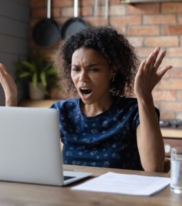 Woman raising her hands in frustration while sitting in front of a laptop, showing what can happen when technology fails during counseling sessions over Zoom or online couples therapy for partners in Florida cities like Miami, Orlando, Tampa, West Palm Beach, Naples, Key West, Tallahassee, Port Saint Lucie, and Lakeland.Relationship Experts in Ft. Lauderdale can help couples addressing whether virtual therapy is awkward.