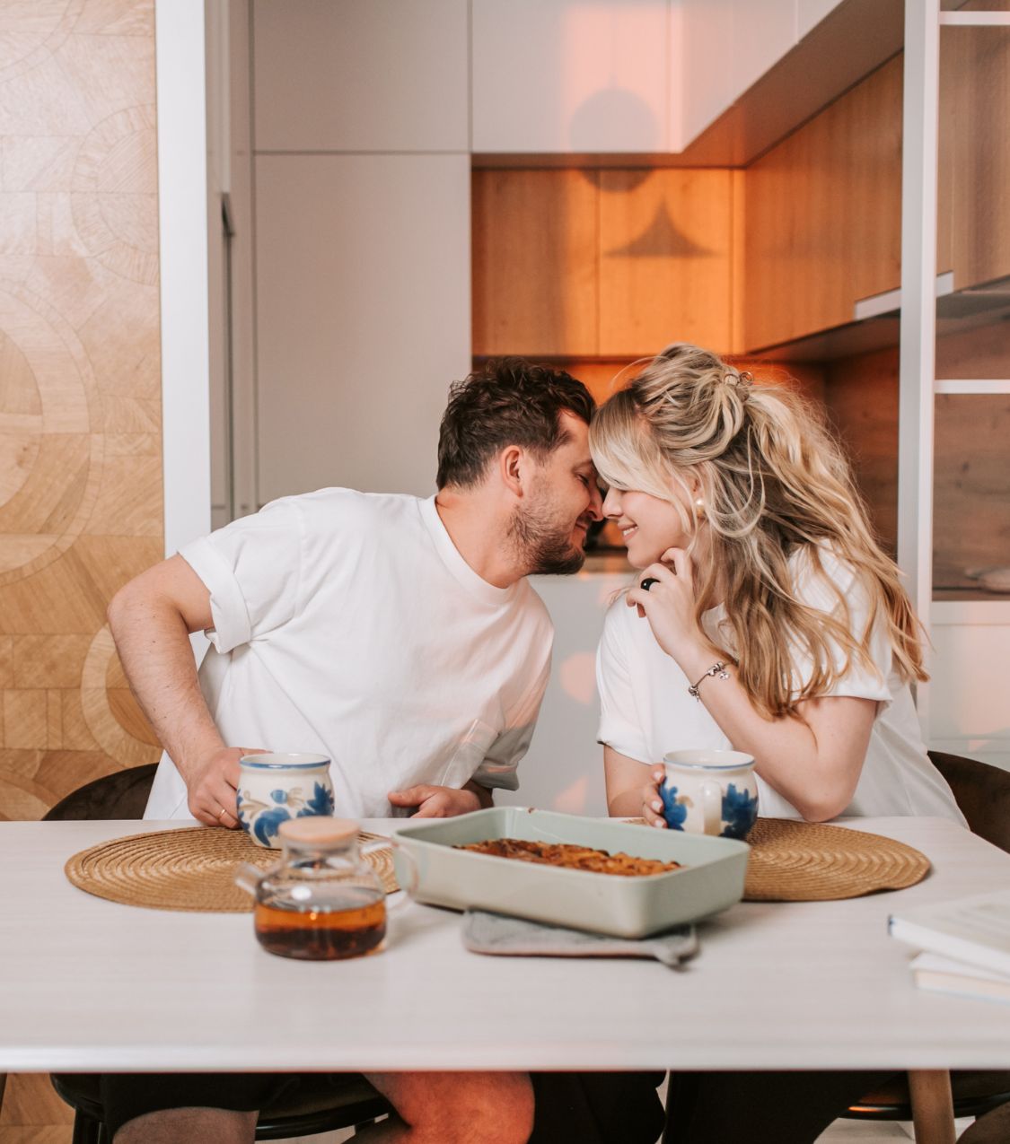 A couple leaning close and reconnecting over breakfast, illustrating how do we fix a relationship after cheating and how a relationship can recover from cheating, with relationship experts support available in Tampa, Miami, West Palm Beach, Naples, Orlando, Key West, Tallahassee, Port Saint Lucie, and Lakeland.