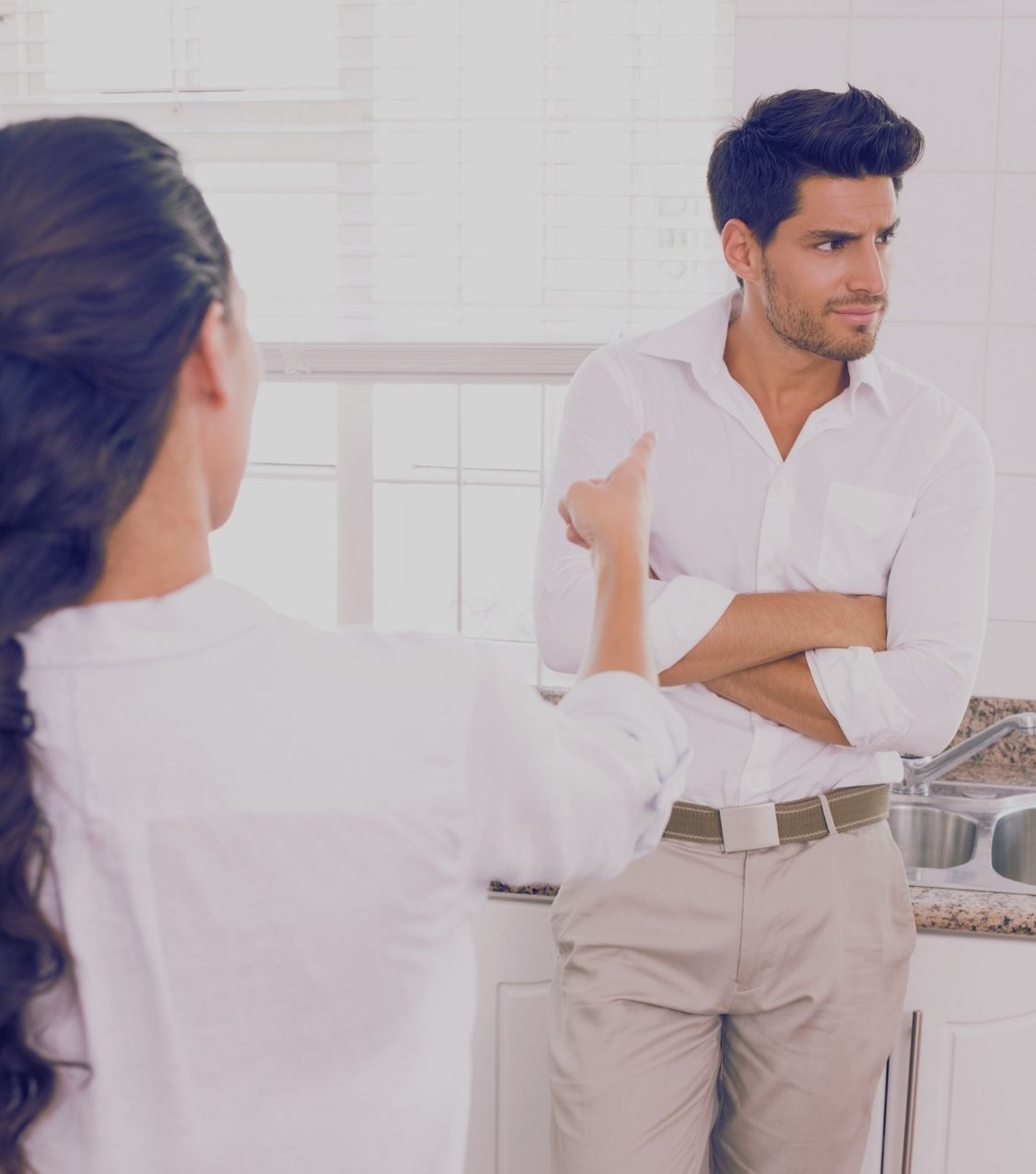 A couple arguing at home as the wife feels defensive with her spouse, reflecting why do I get so defensive and how couples therapy in Florida can help rebuild connection.