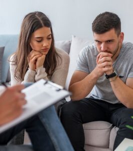 Distressed couple receiving advice from marriage counselors on where to start after infidelity and healing after betrayal. Online sessions in Orlando, Fort Lauderdale, and West Palm Beach. Schedule a free consultation today